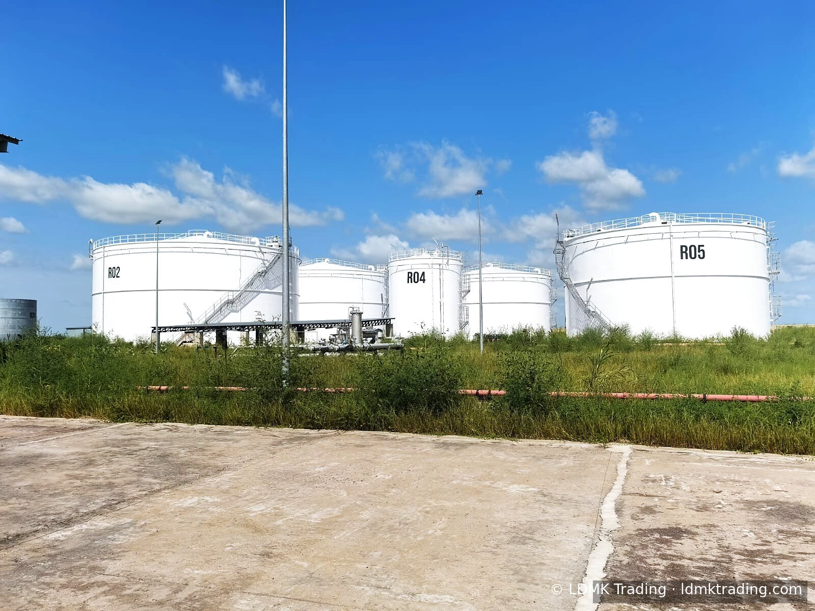 White storage tanks labelled R02, R04 and R05 on a CEMAC product terminal.