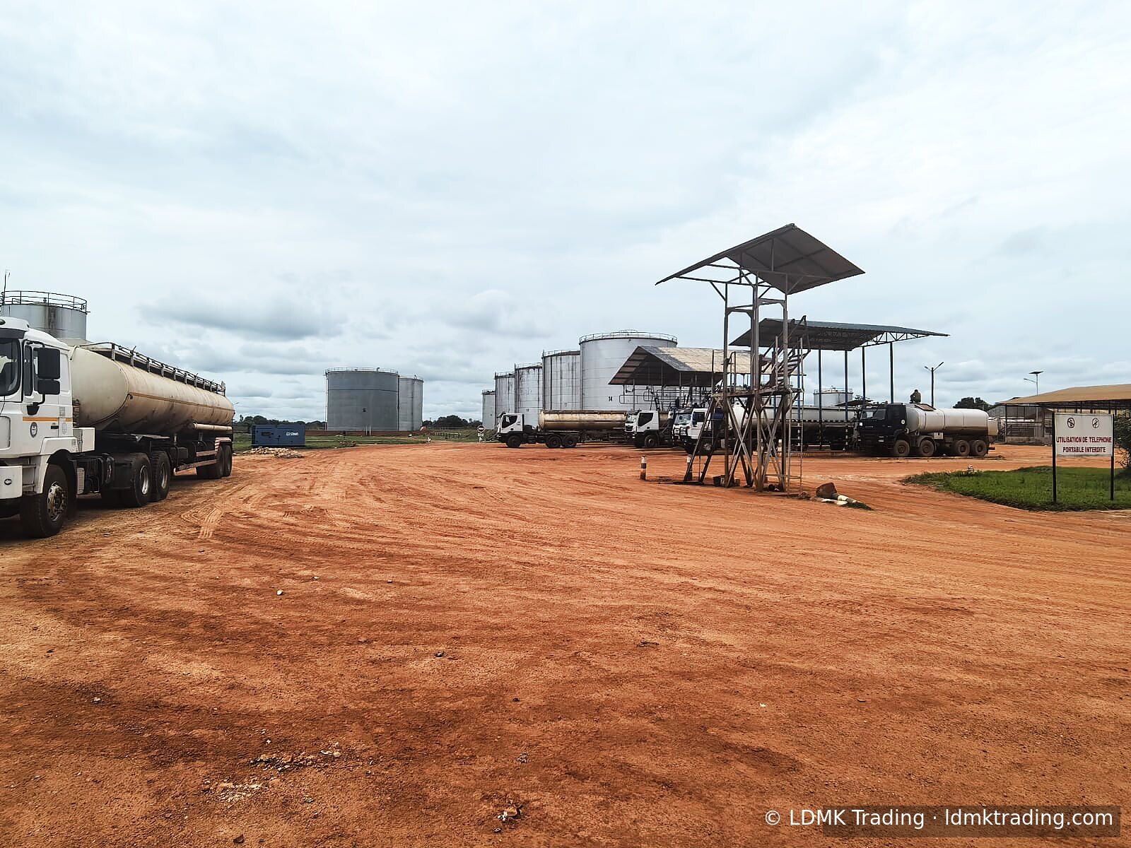 LDMK terminal with a fleet of road tankers on compacted red-earth apron.